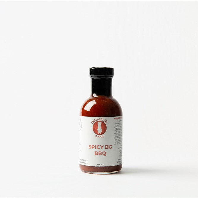 Bottle of Spicy BG BBQ sauce with a white label on a white background