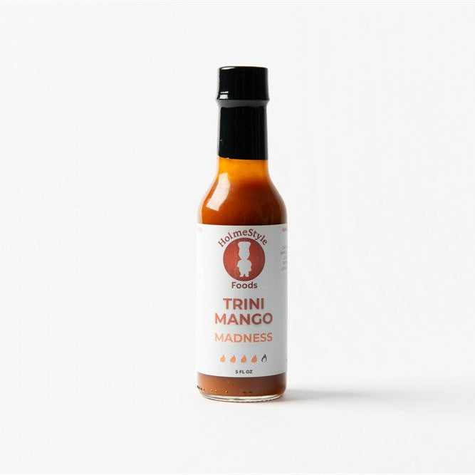 Bottle of Trini Mango Madness hot sauce on a white background