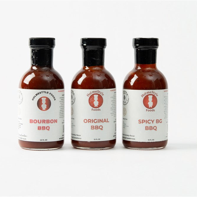 Three bottles of BBQ sauces on a white background