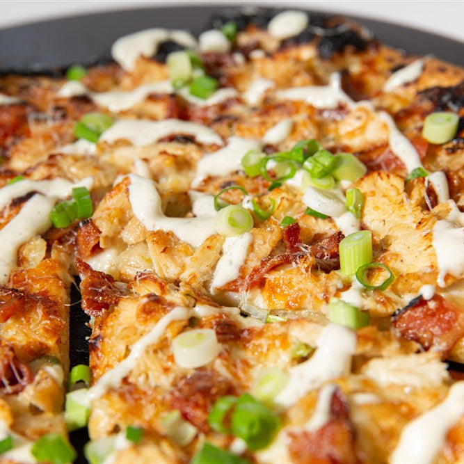 Grilled Pizza with bacon, cheese and green onions on a pan