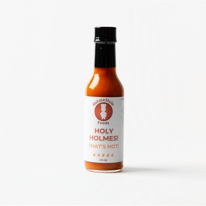 Hot sauce bottle labeled 'Holy Holmes! That's Hot' on a white background