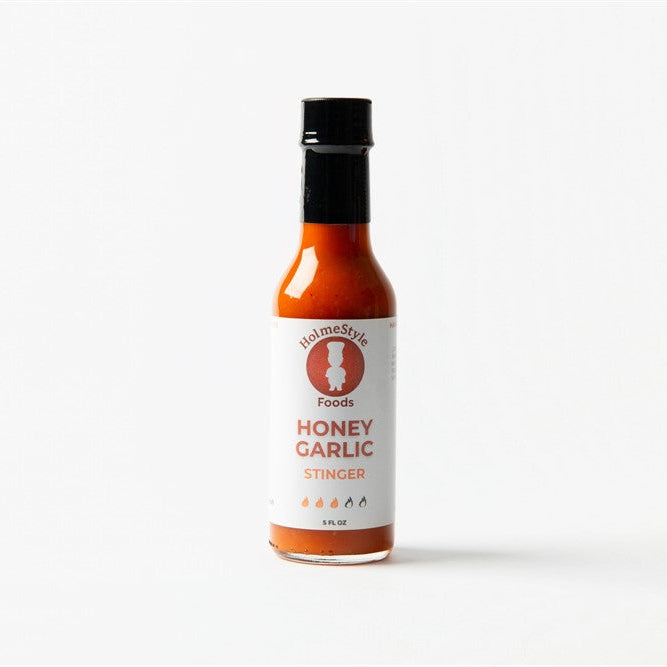 Bottle of honey garlic sauce on a white background