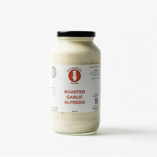 Jar of roasted garlic Alfredo sauce on a white background