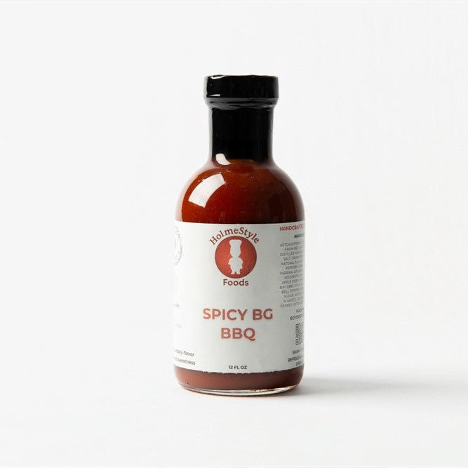Bottle of Spicy BG BBQ sauce with a white label on a white background