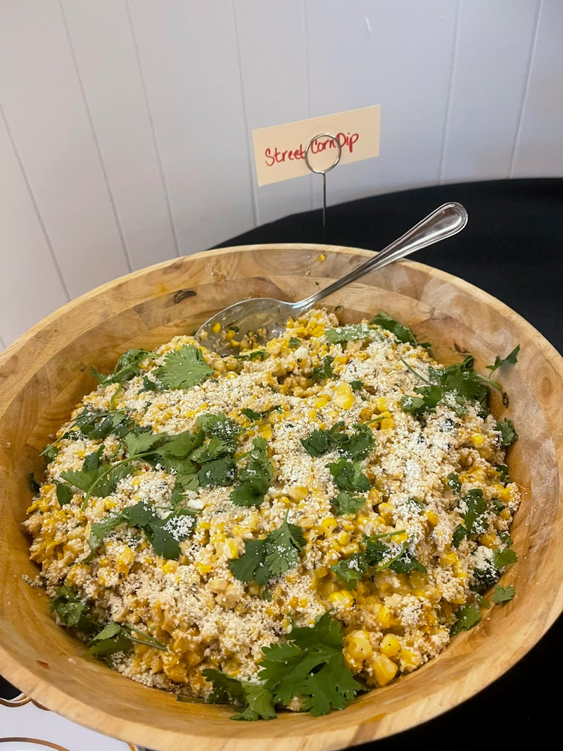 Wooden bowl with a salad on a white surface