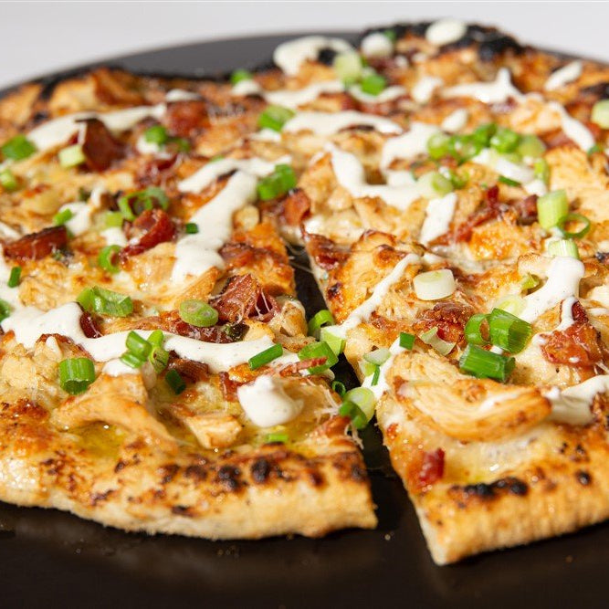 Grilled Pizza with bacon, cheese and green onions on a pan